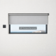 Ventana rectangular con persiana automática gris a medio bajar; cielo azul y silueta de tejados en el fondo. Donde puedo comprar persianas automaticas con instalacion incluida en Barcelona.